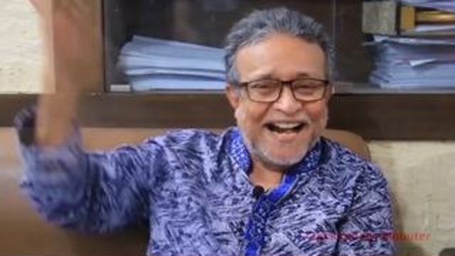 old man laughs waving